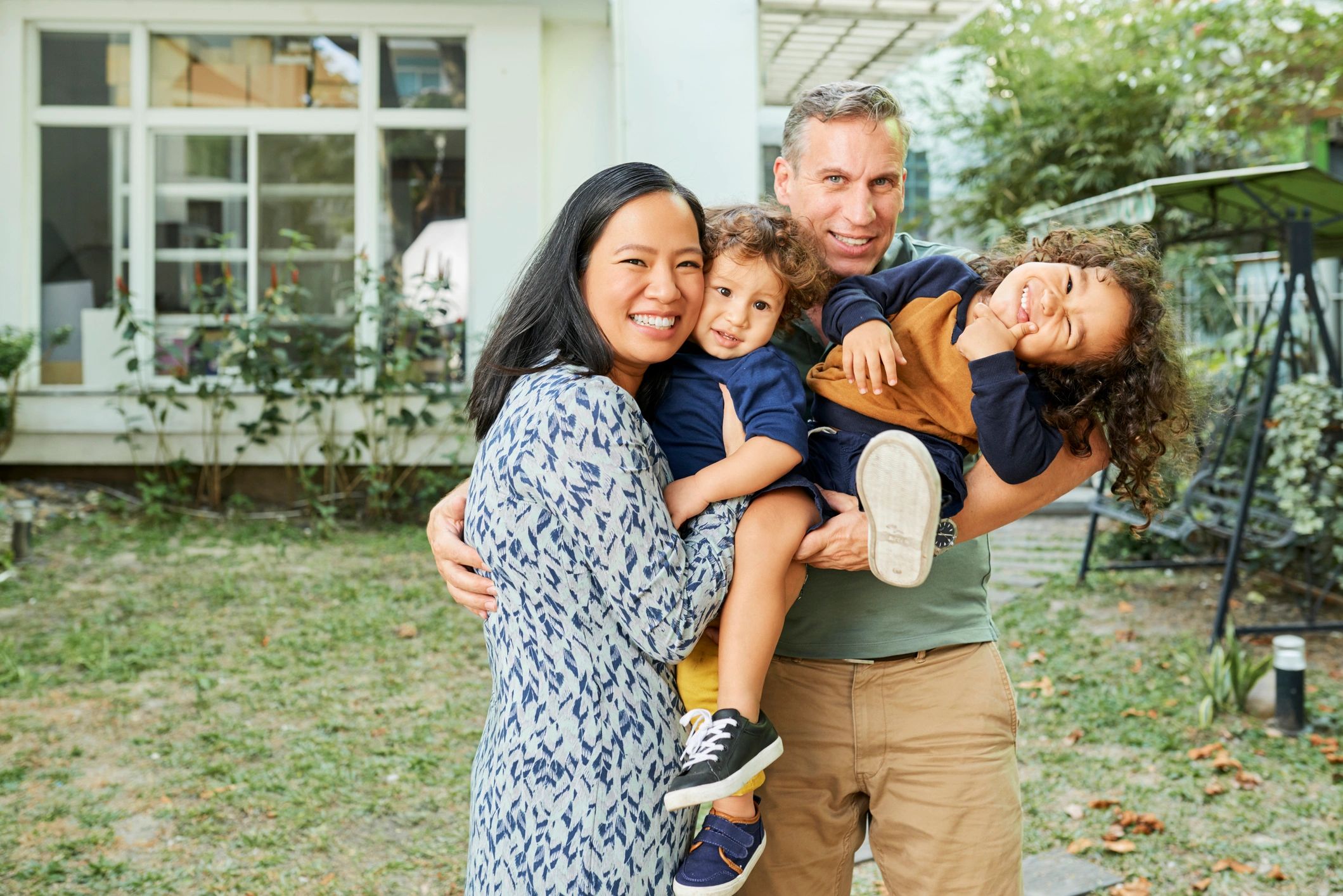 Parents and children smiling in their backyard