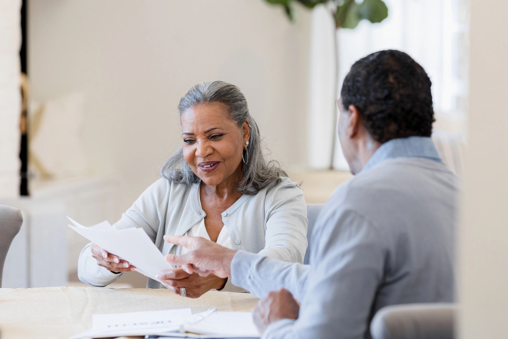 Insurance agent explaining documents to a senior client