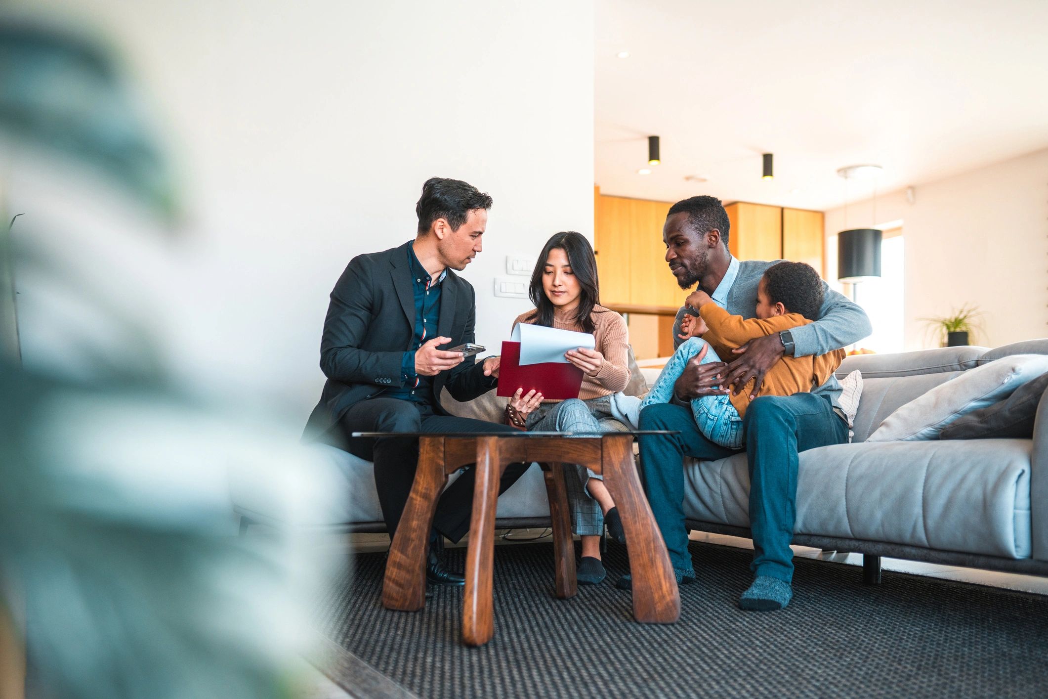Family meeting with an agent in a living room