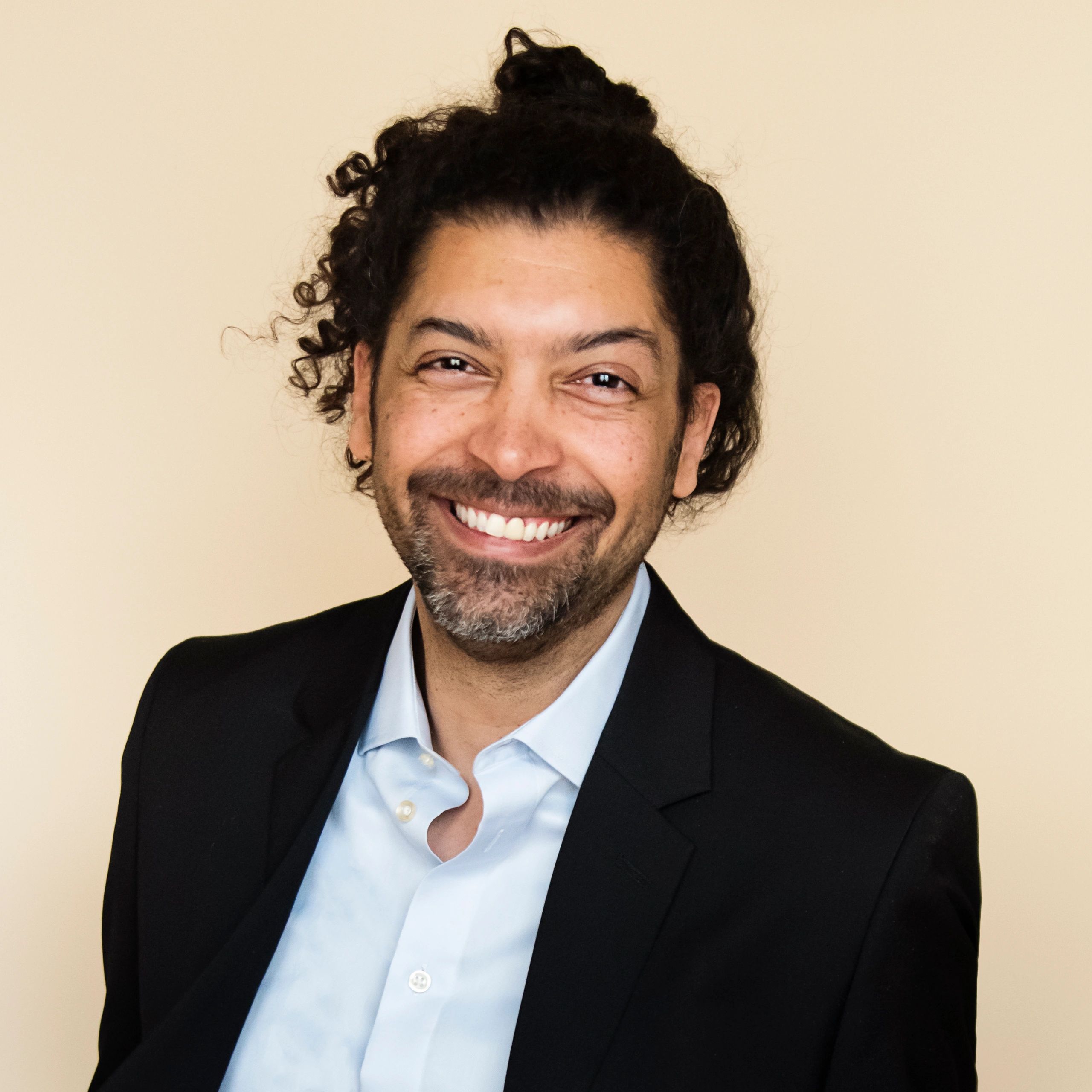 Professional headshot of a man in a suit