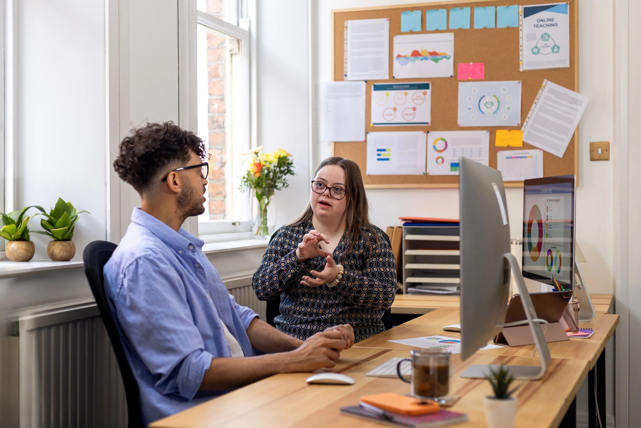 Two professionals discussing coverage at a desk