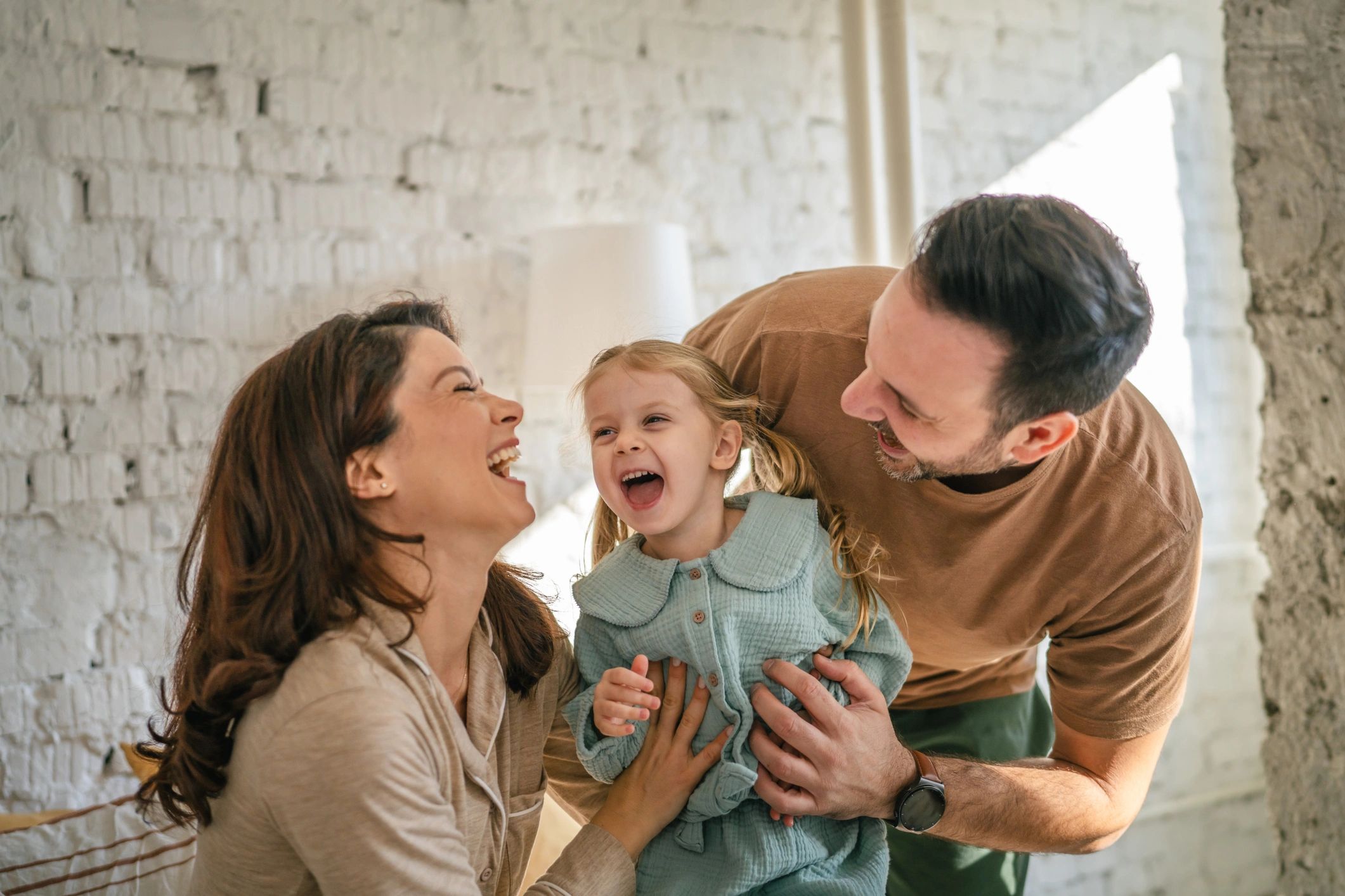 Happy family laughing together at home